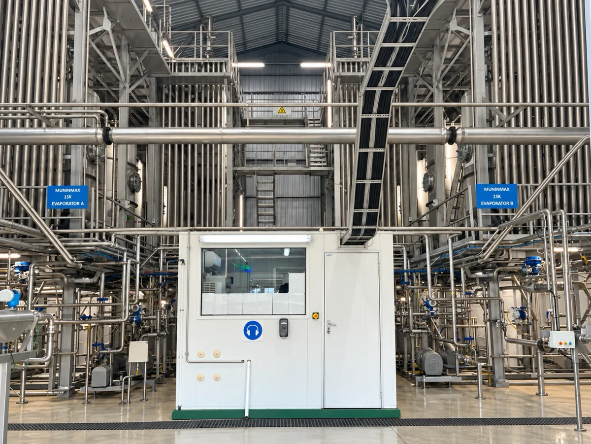 Evaporator system with vertical vessels, pipework, access platforms and a control enclosure.
