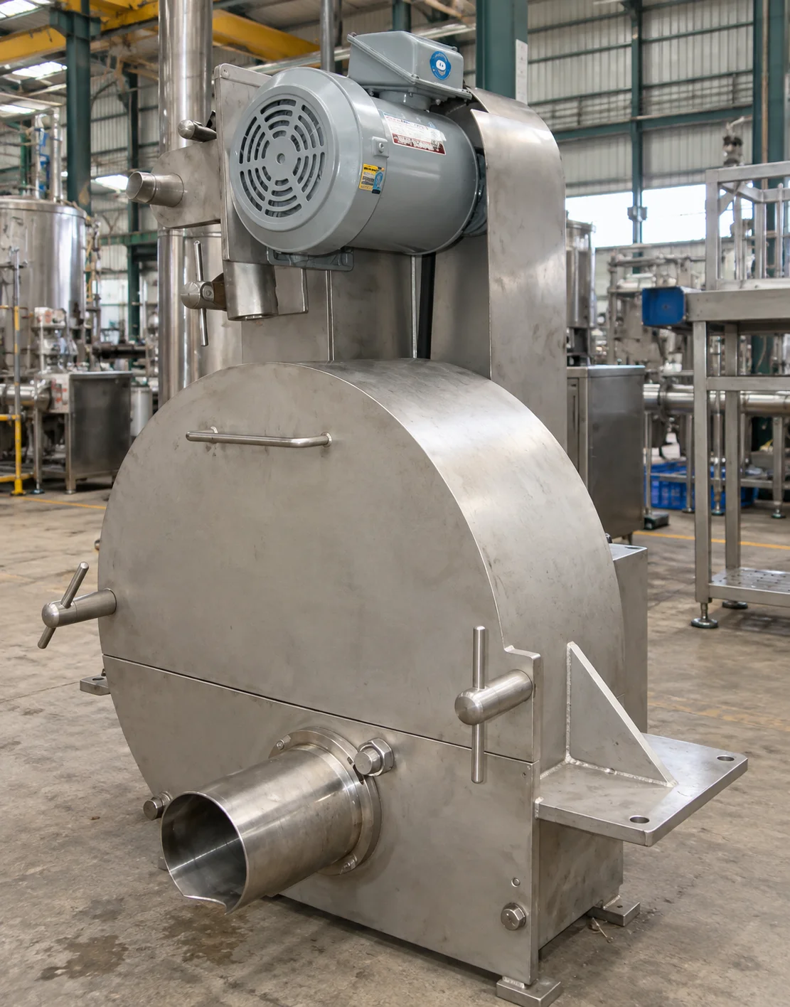 Stainless-steel slicer with an upper motor, enclosed cutting chamber and cylindrical front opening.
