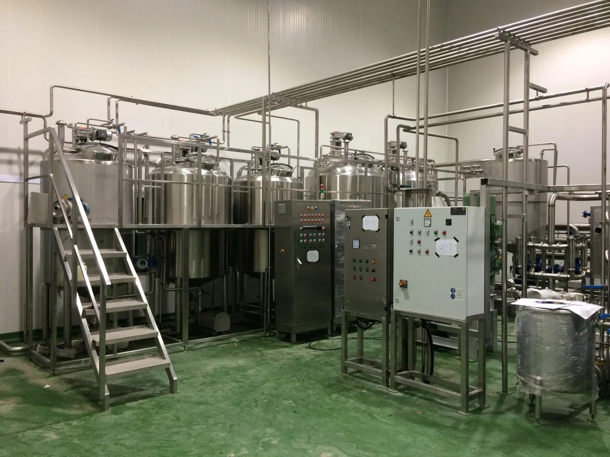 Stainless-steel holding tanks connected by pipework.