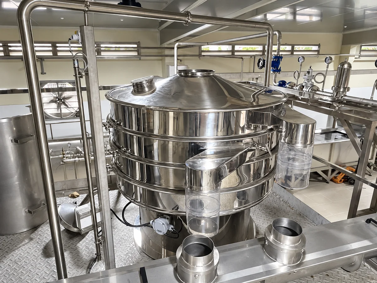 Multi-deck circular stainless-steel vibrating screen with a cover and side outlets.