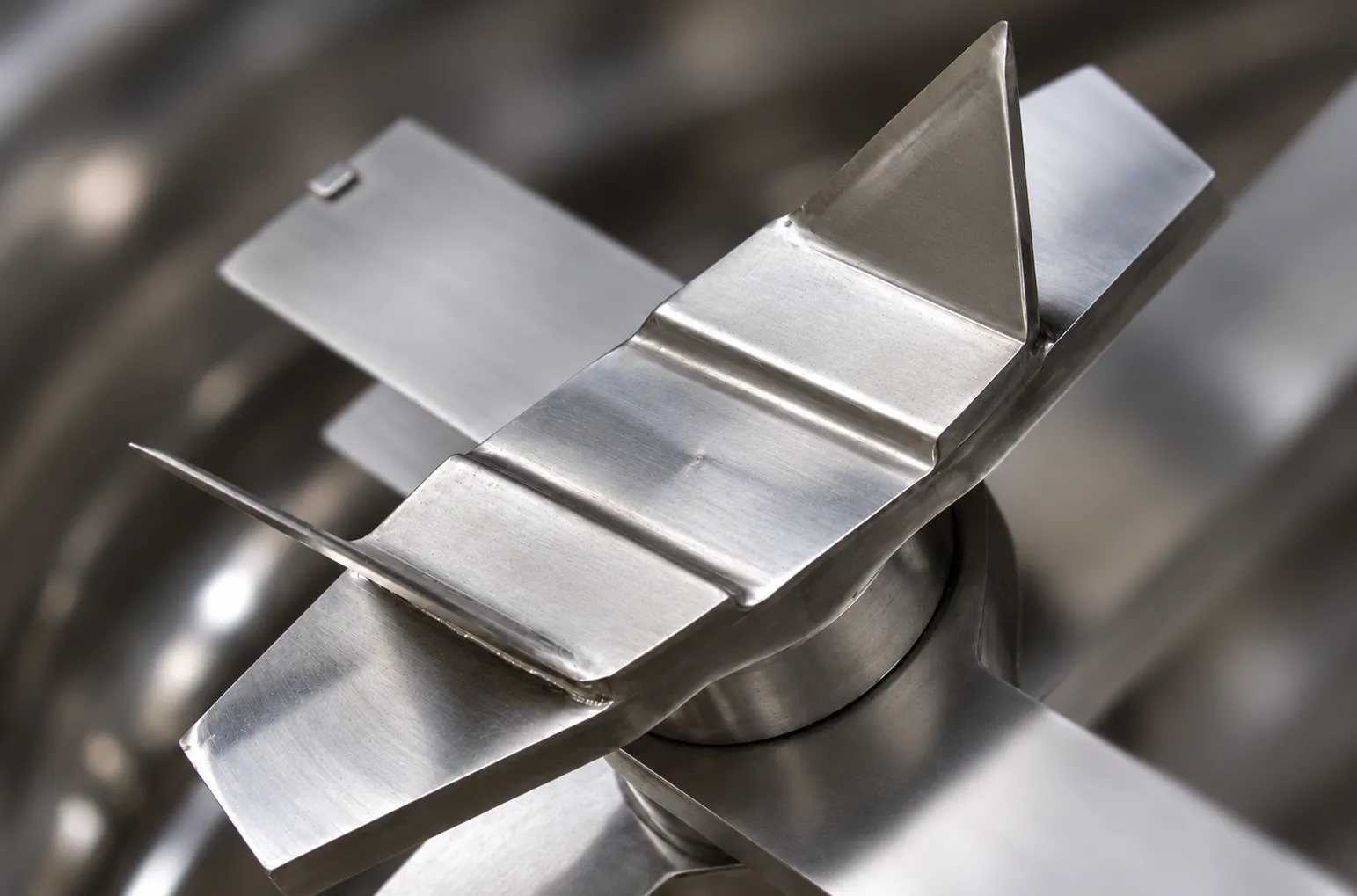 Crossed metal blades in a Knife Crusher blade assembly.