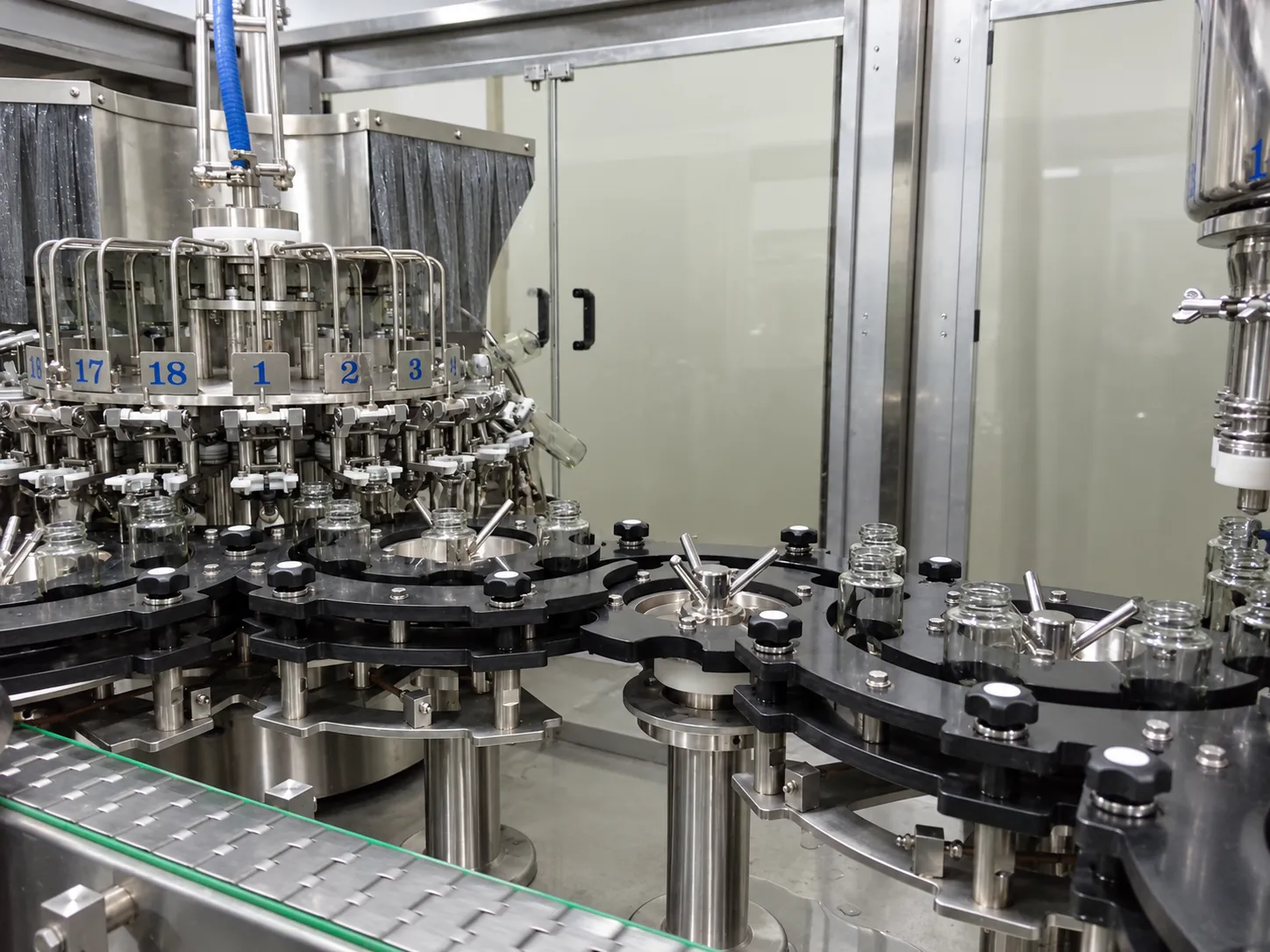 Rotary Liquid Filling: Rotary filling carousel and container transfer.