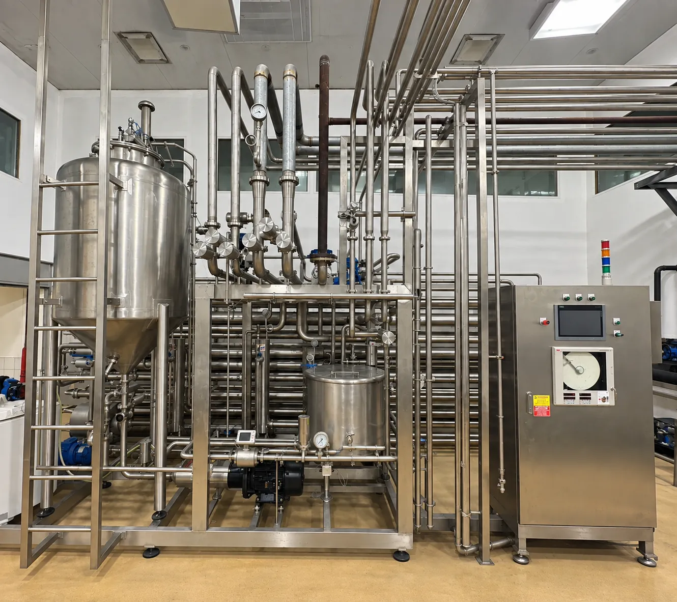 UHT system with pipework and a control cabinet.